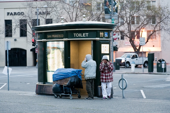 Two people emerge from the public toilet in front of City Hall in San Francisco.